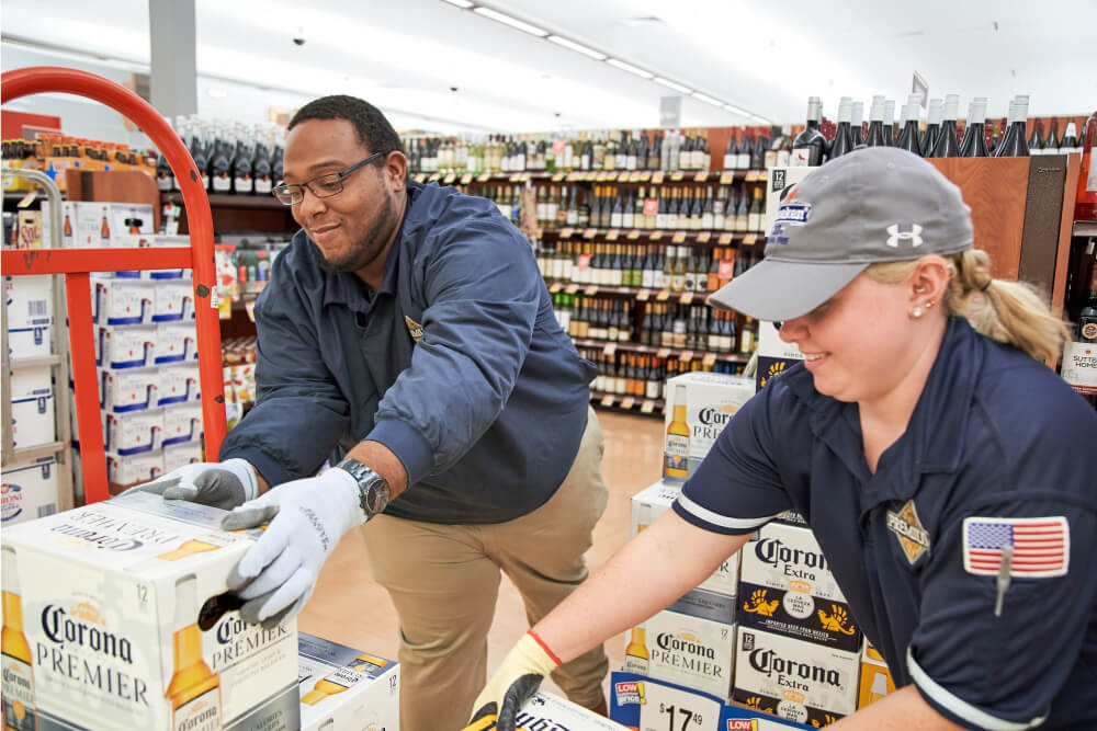 Merchandisers stocking Corona brand products in store