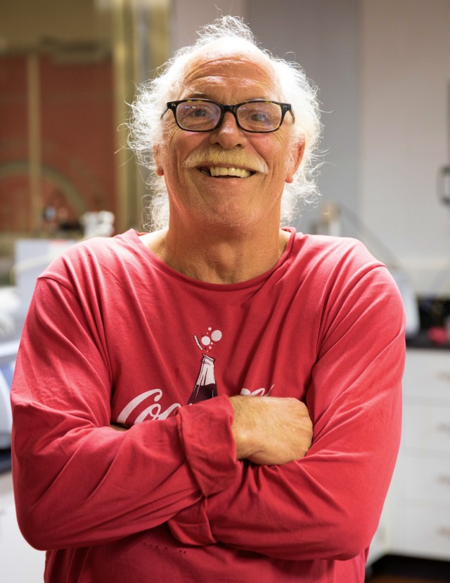 Older man in a Coca-Cola shirt smiling at camera