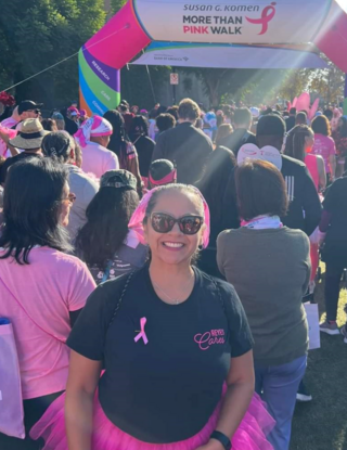 Woman smiling during breast cancer awareness walk wearing all pink