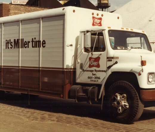 Vintage Miller truck with 'Chicago Beverage Systems' printed on door and 'it's Miller time' on the truck