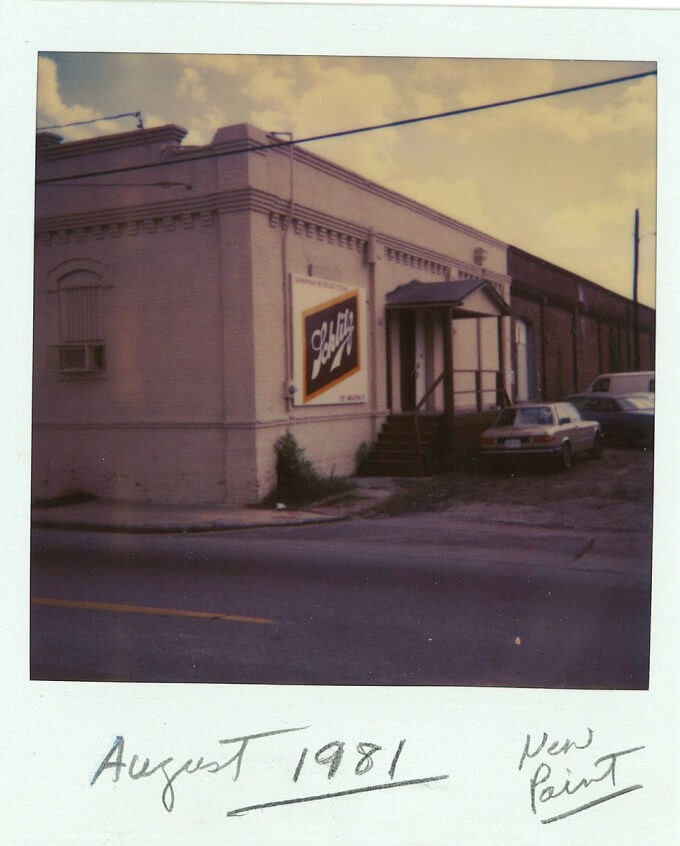 Polaroid of building with Schlitz banner on side. August 1981, new paint written on polaroid.